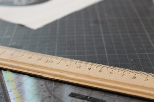 wooden ruler for measuring length sitting on desk